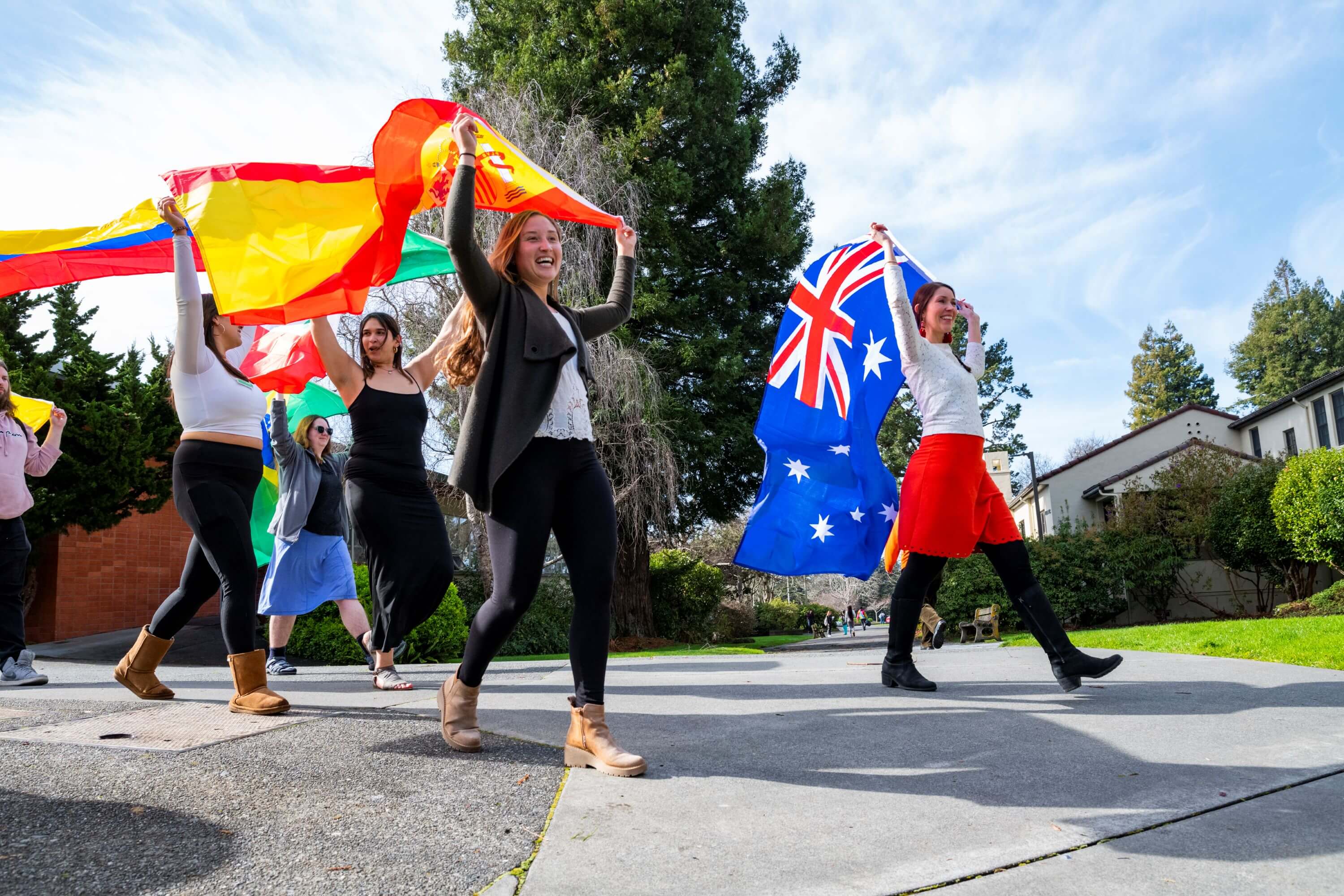 a group of college students waving international flags