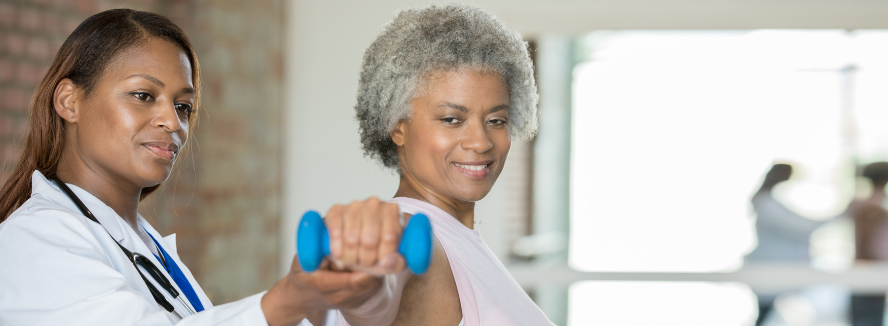 physical therapist helping woman