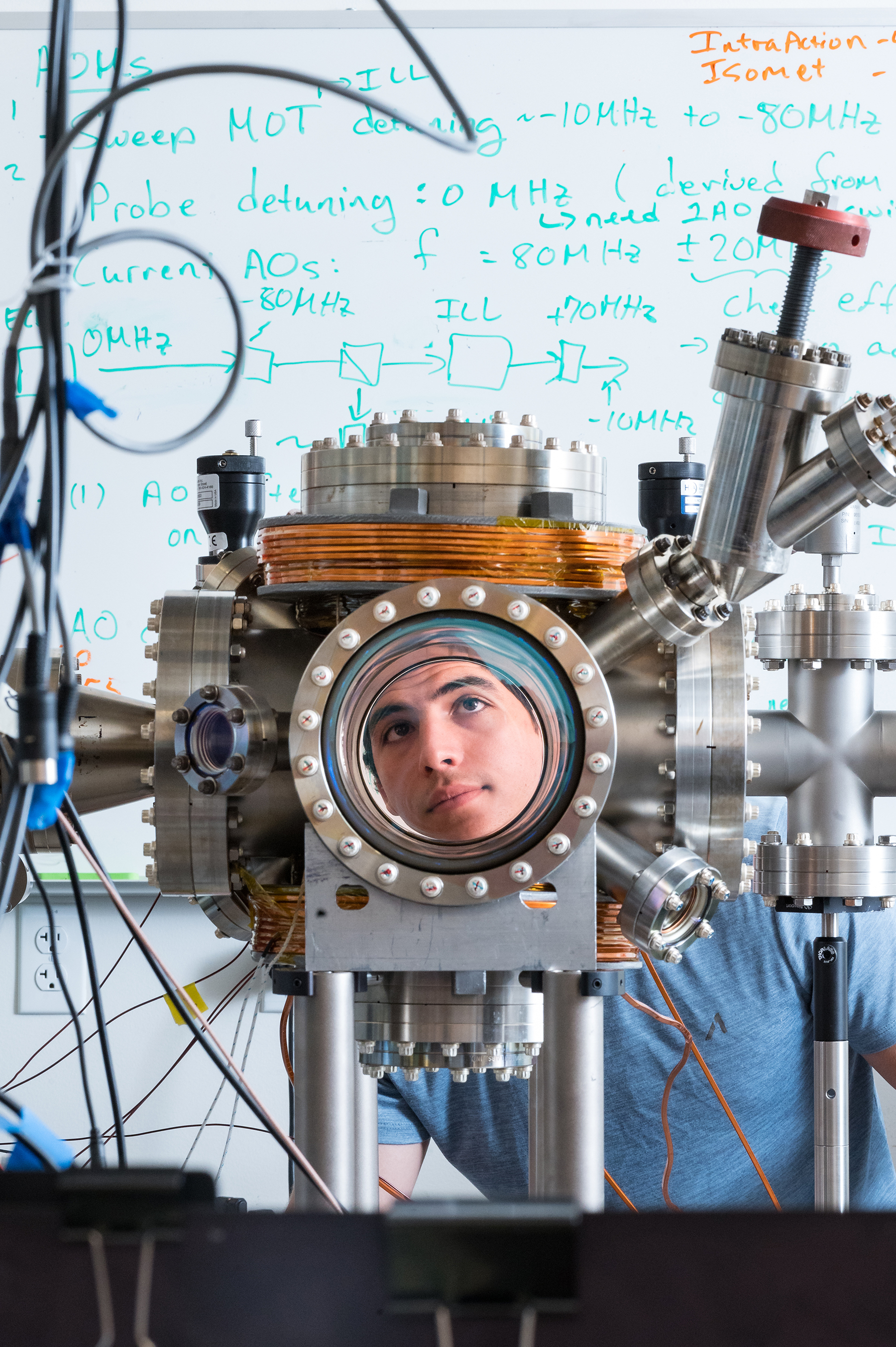 Student Toni Grubesic looks through the viewport of the ultrahigh vacuum chamber at Chico State's ultracold laboratory.