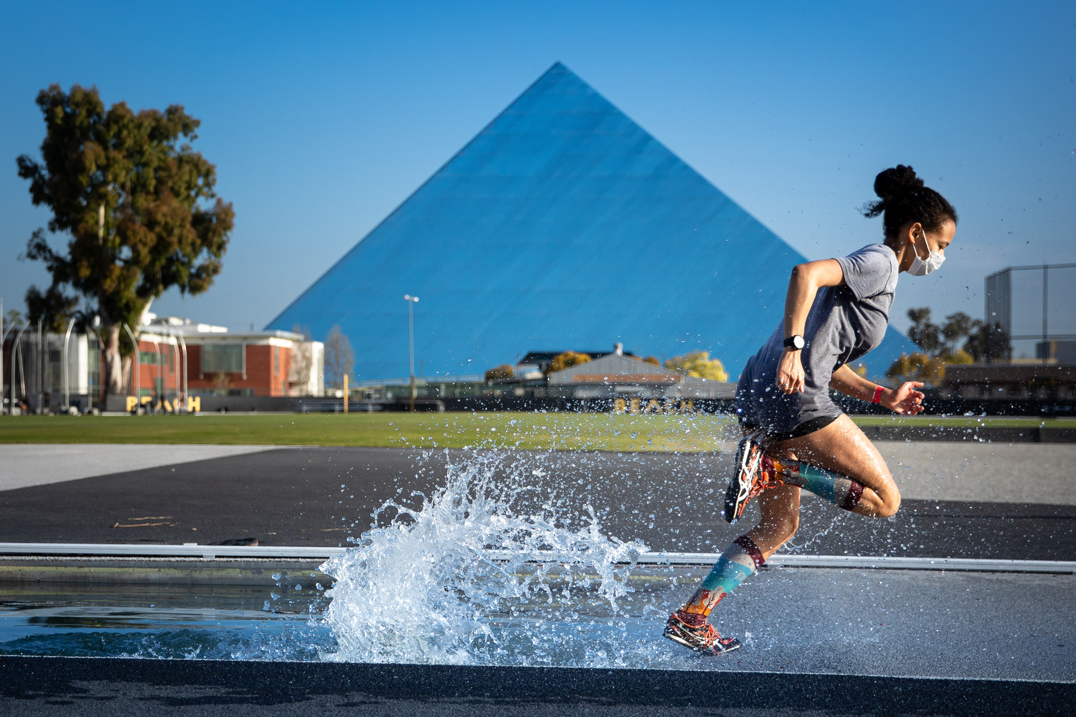 Cal State Long Beach track and field athlete T​iana Prince runs in front of the iconic Walter Pyramid.