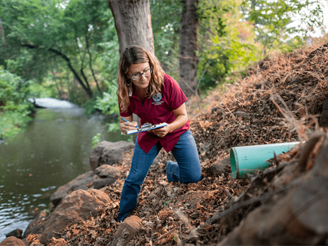 Industrial Hygienist &amp; Environmental Program Manager Holly Swan checks creek out flows.