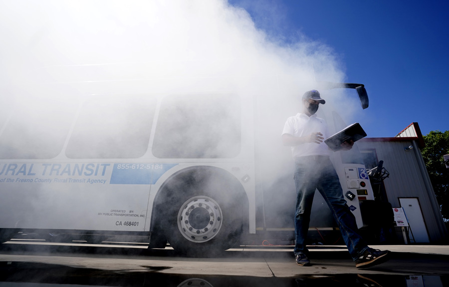 Dr. Aly Tawfik exits a Fresno County Rural Transit Authority bus amid clouds of white smoke generated by non-toxic candles during the team's airflow simulation study.