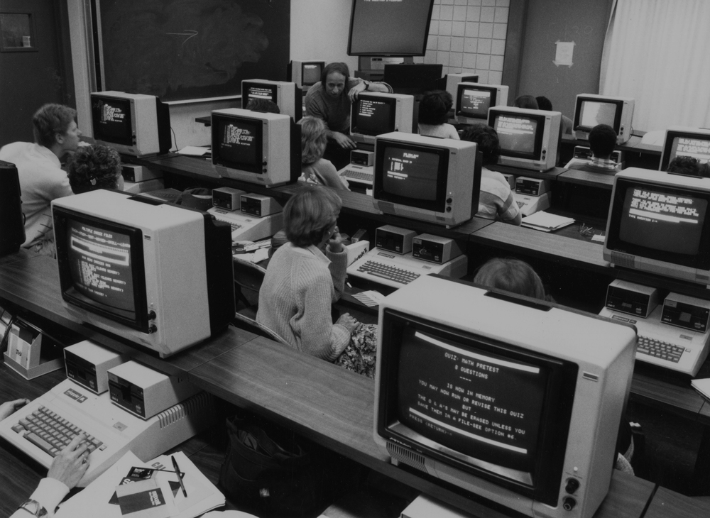 Students working in a classroom with legacy computers