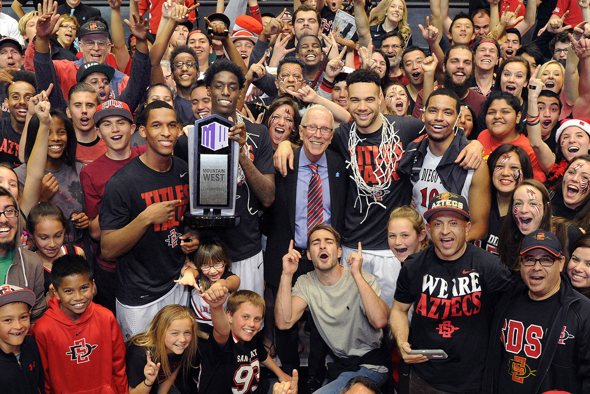 SDSU men’s basketball players and coach Steve Fisher pose for a photo after winning the Mountain West League Championship. (Photo predates COVID-19.)