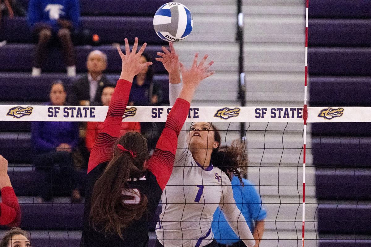 San Francisco​​San Francisco State volleyball player Drew Morris goes head-to-head at the net against a Saint Martin’s University player during an August 