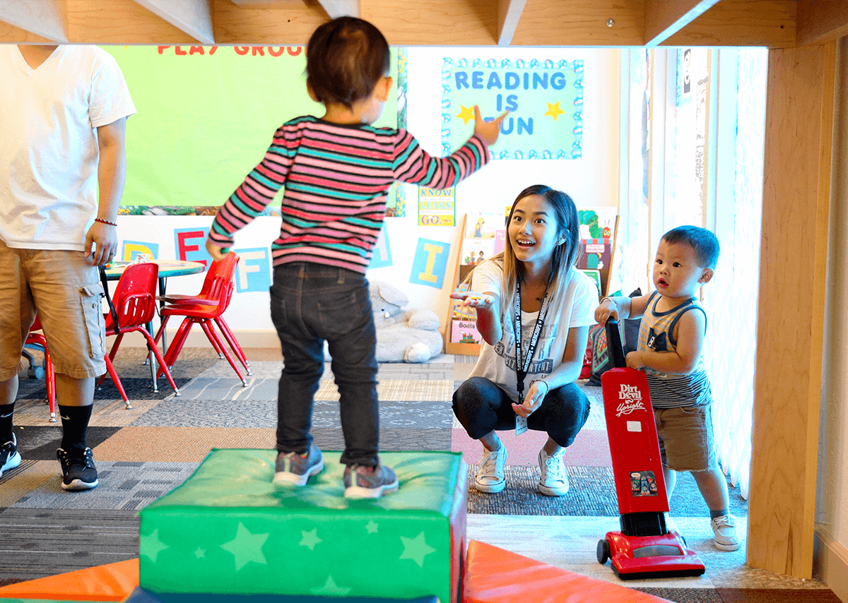 Children playing with their teacher in their pre-kindergarten classroom