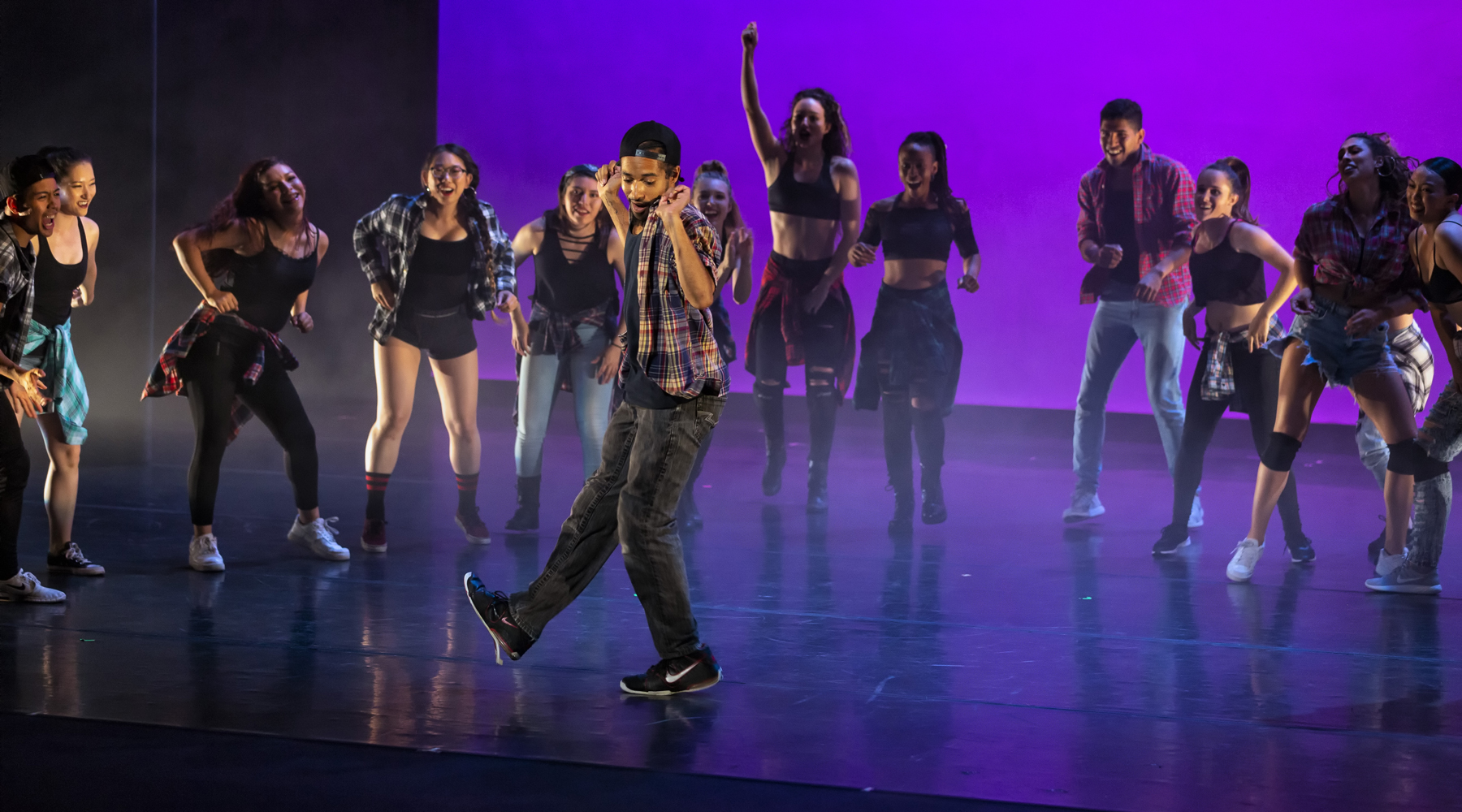 young men and women dancing in a stage production