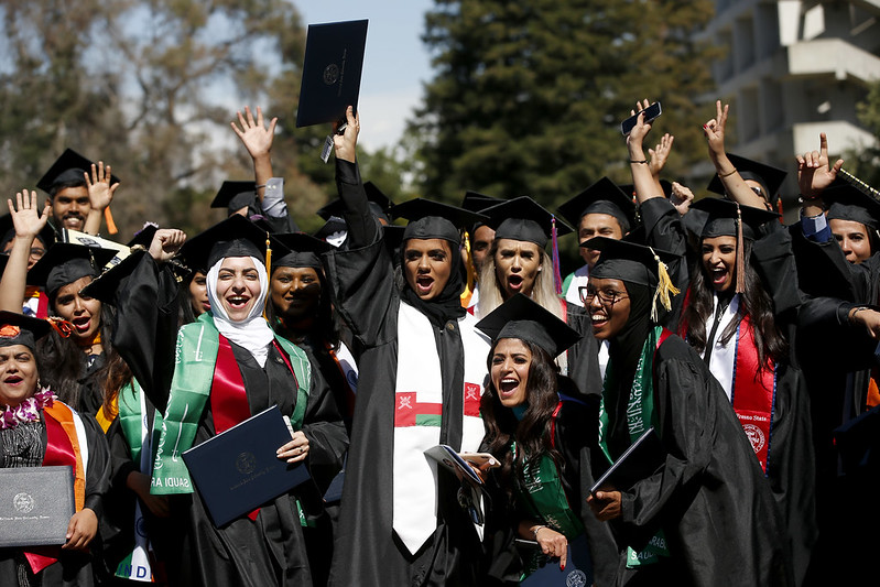 women cheering and celebrating at graduation ceremony