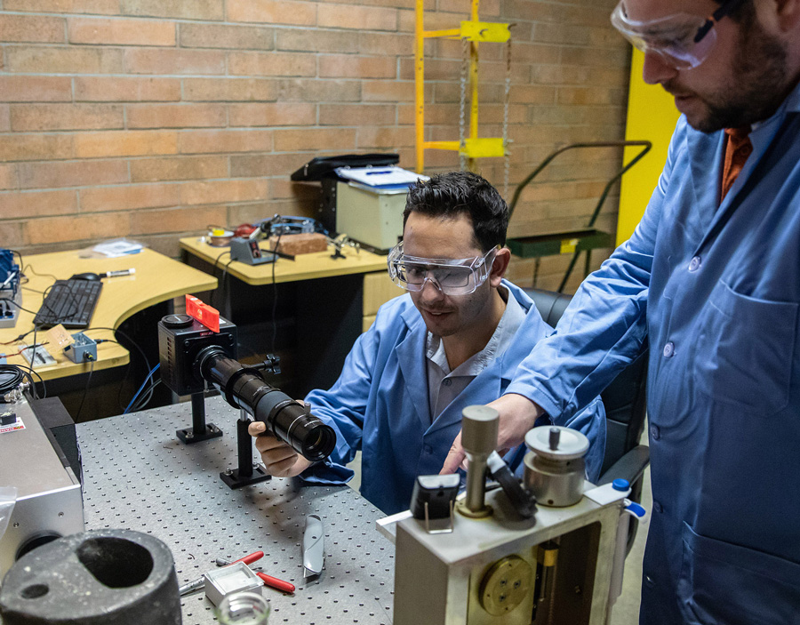 Dr. Joseph Kalman and undergraduate student David Ramirez set up an experiment to test rocket propellent.