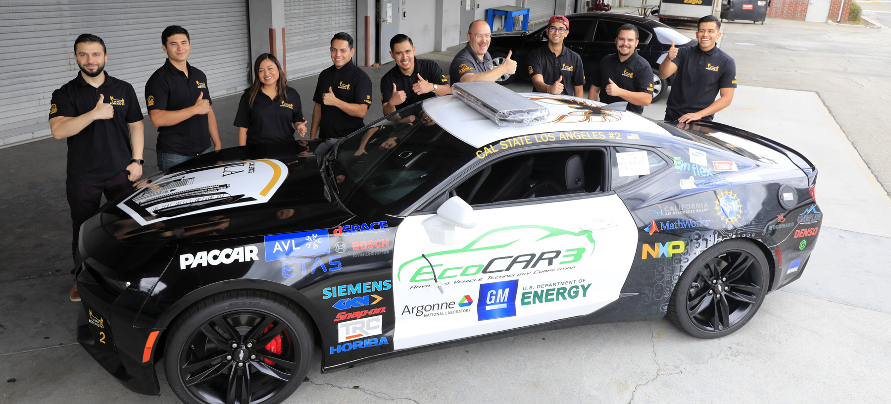 Dr. David Blekhman with the EcoCAR3 team and their Chevrolet Camaro.