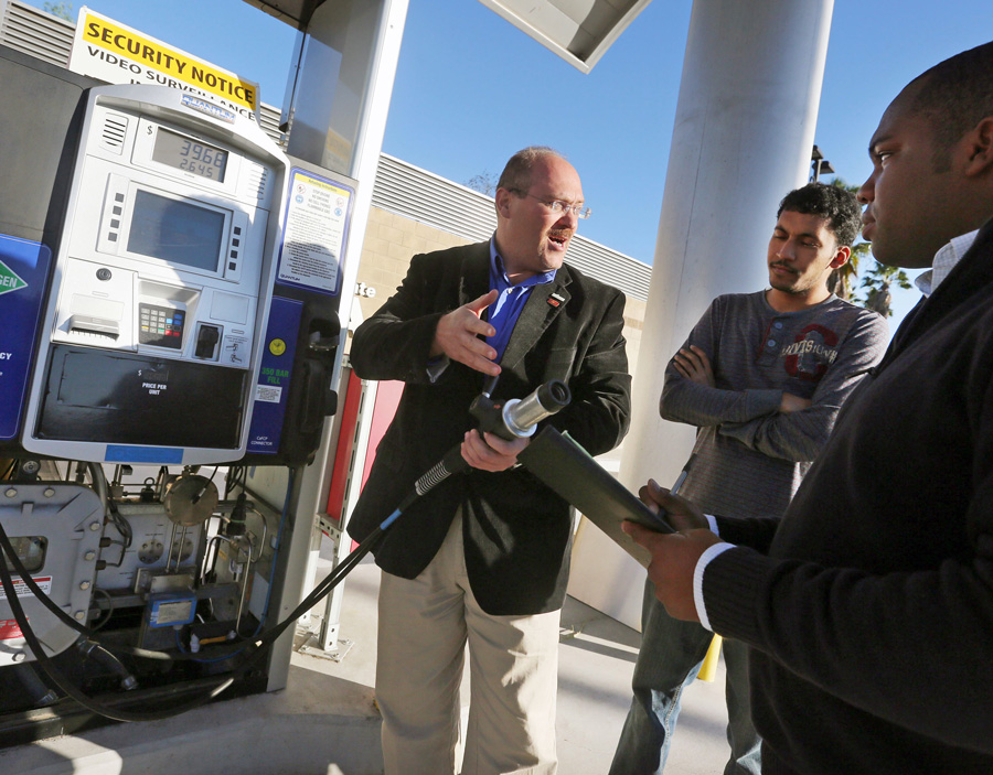 Dr. David Blekhman holding a fueling nozzle at the Cal State LA Hydrogen Research and Fueling Facility.