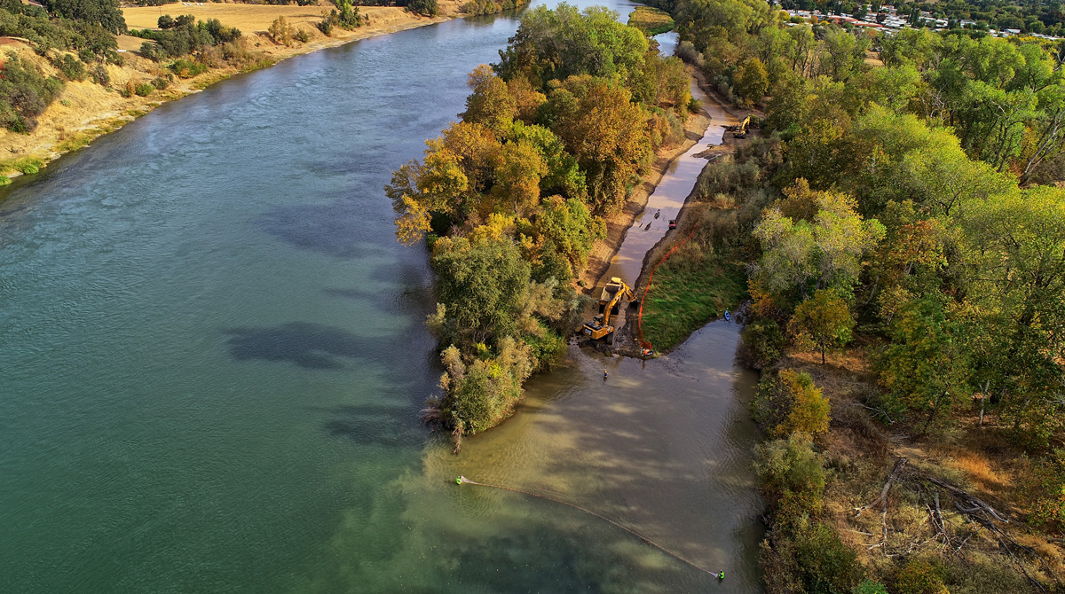 Aerial view of construction vehicles working in the river.