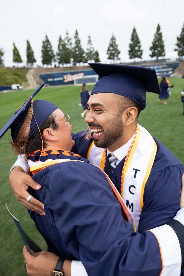 graduating students hugging