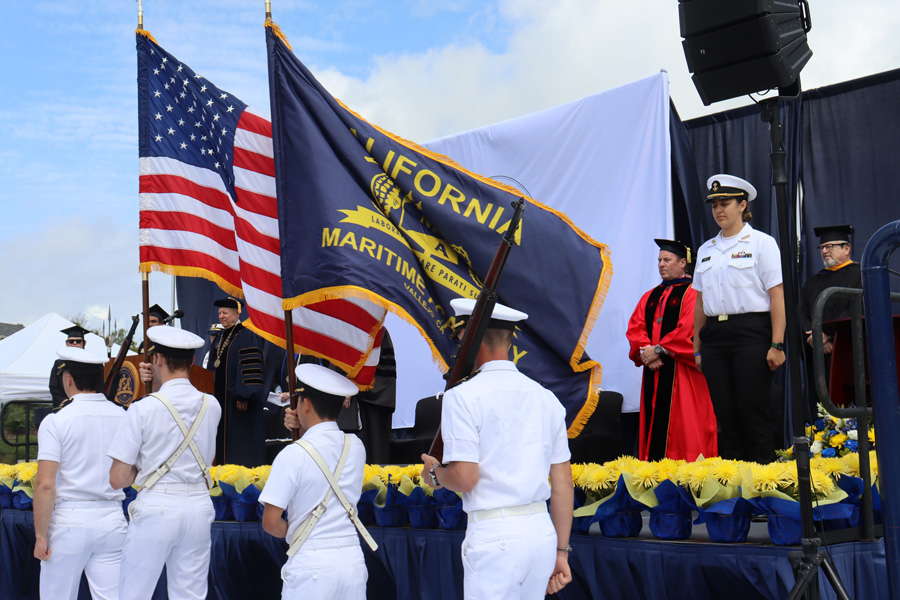 color guard cadets carry california and cal maritime flags into ceremony