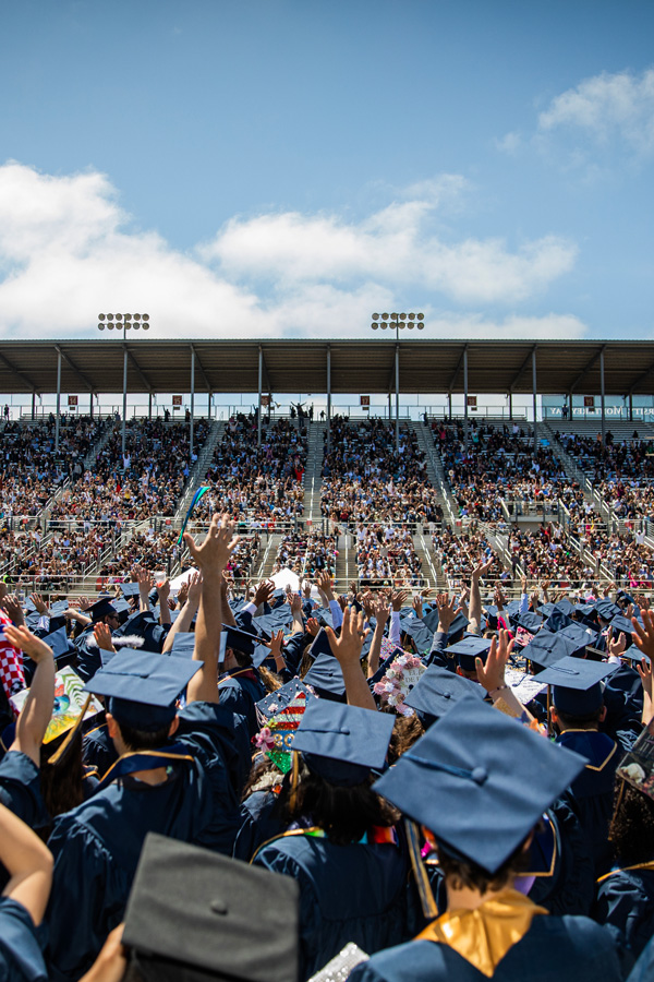 graduating students wave to crowd