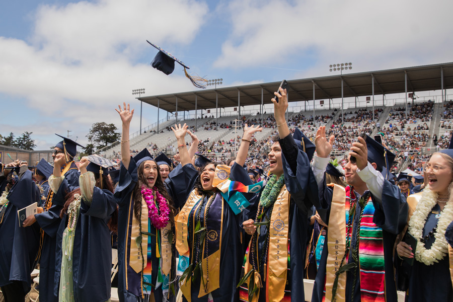 graduating student throws cap in the air