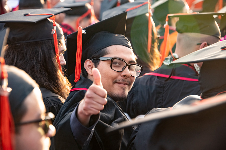 graduating student giving a thumbs up
