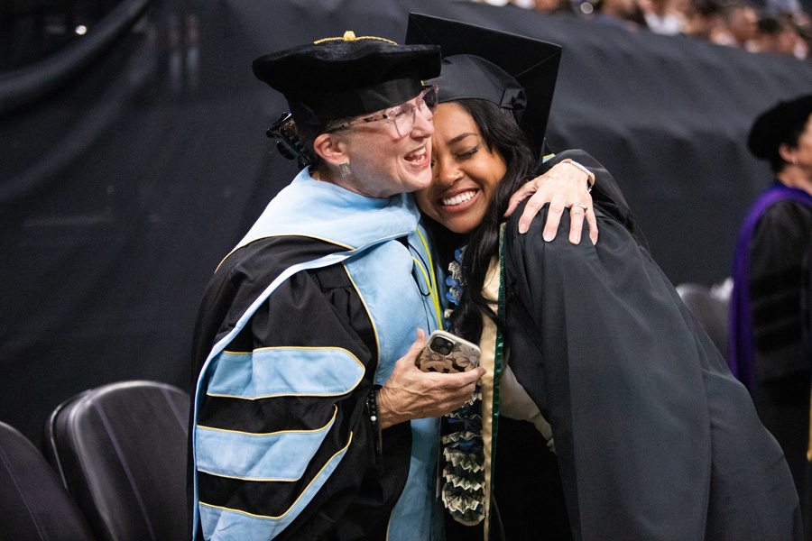 graduating student embraced by professor