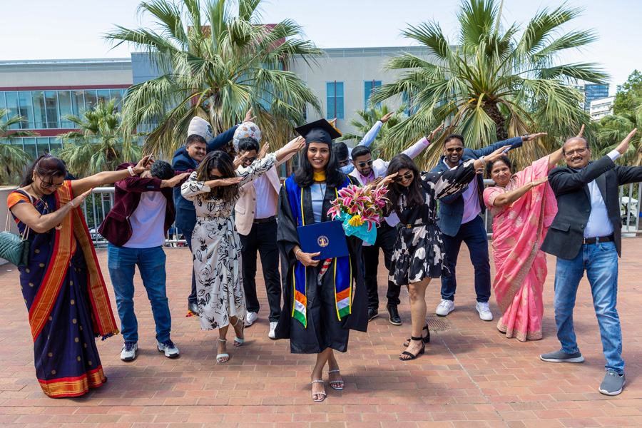 graduating students family holding their arms in the dab pose