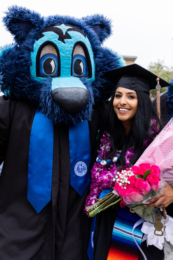 graduating student with sonoma state mascot lobo the seawolf