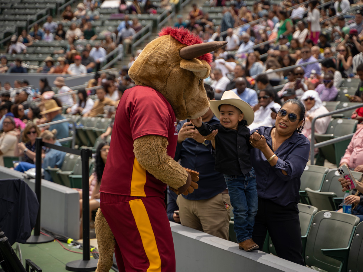 a bull mascot playing with a child