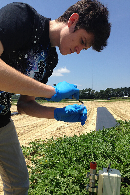Aidan Shands testing agriculture in a field