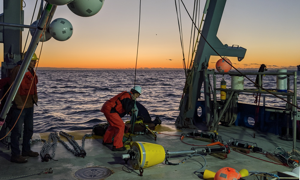 men using equipment aboard Maritime Academy’s Golden Bear Research vessel