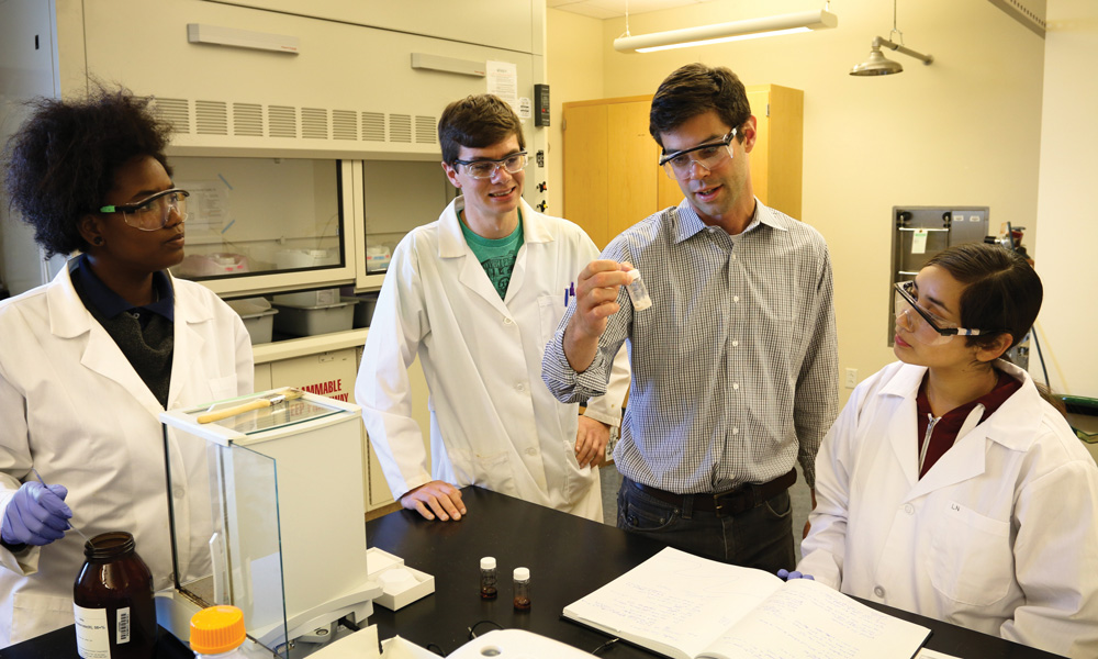 CSUMB assistant professor​ John Goeltz with students in lab setting