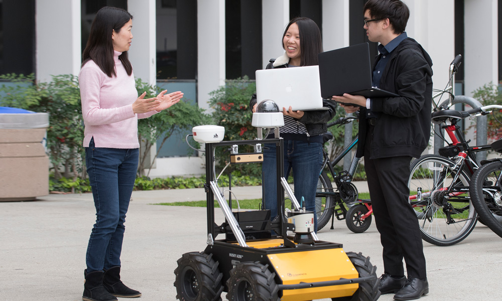 Cal Poly Pomona students with an autonomous driverless vehicle prototype