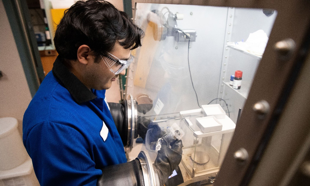 CSU San Marcos student Omar Apolinar working with lab equipment