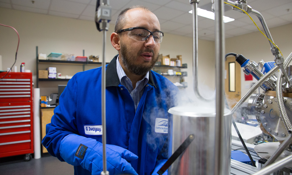 Cal State San Marcos physics professor Dr. Gerardo Dominguez works in a lab
