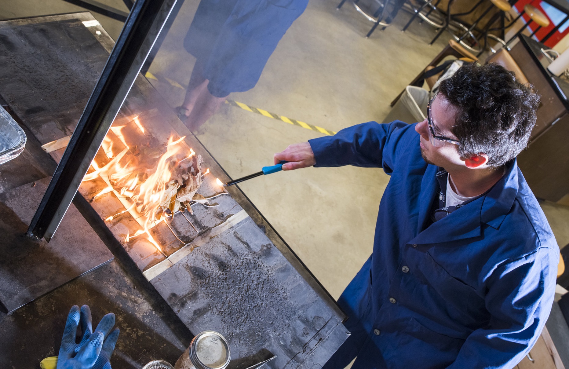 student lighting fire to an experiment in the lab