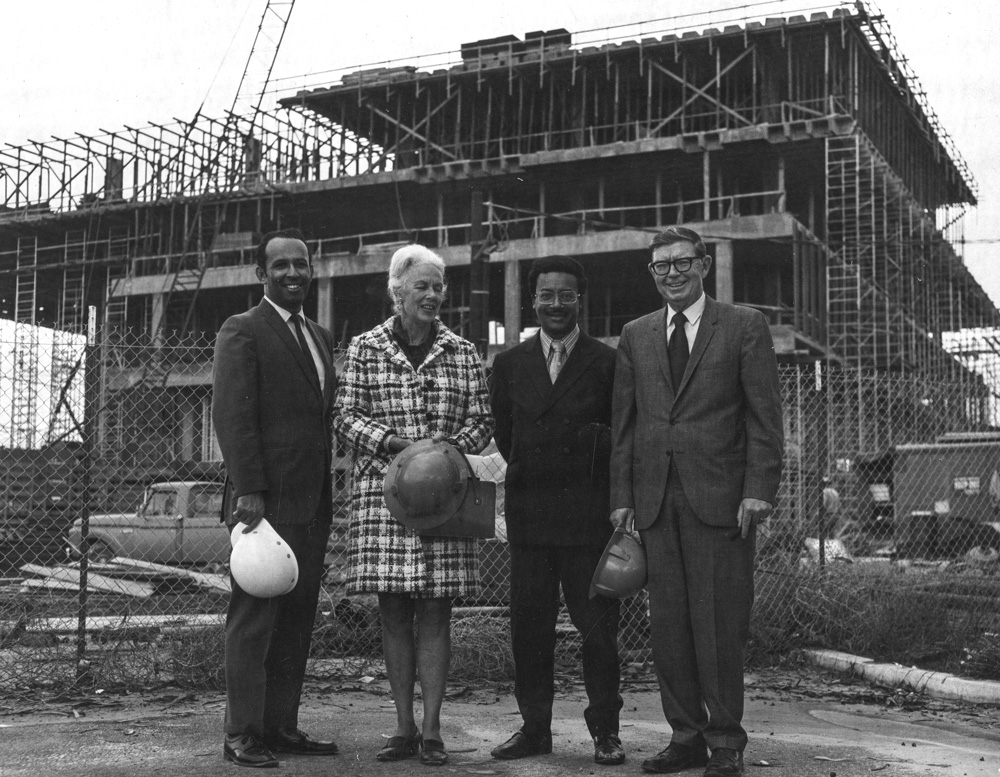 DOM​INGUEZ HILLS   1971Former president of CSU Dominguez Hills Leo Cain stands with administrators and campus visitors in front of the new library’s framework.                  Left to right: Gilbert Smith, Polly Watts, Assemblyman Leon Ralph, President Cain.