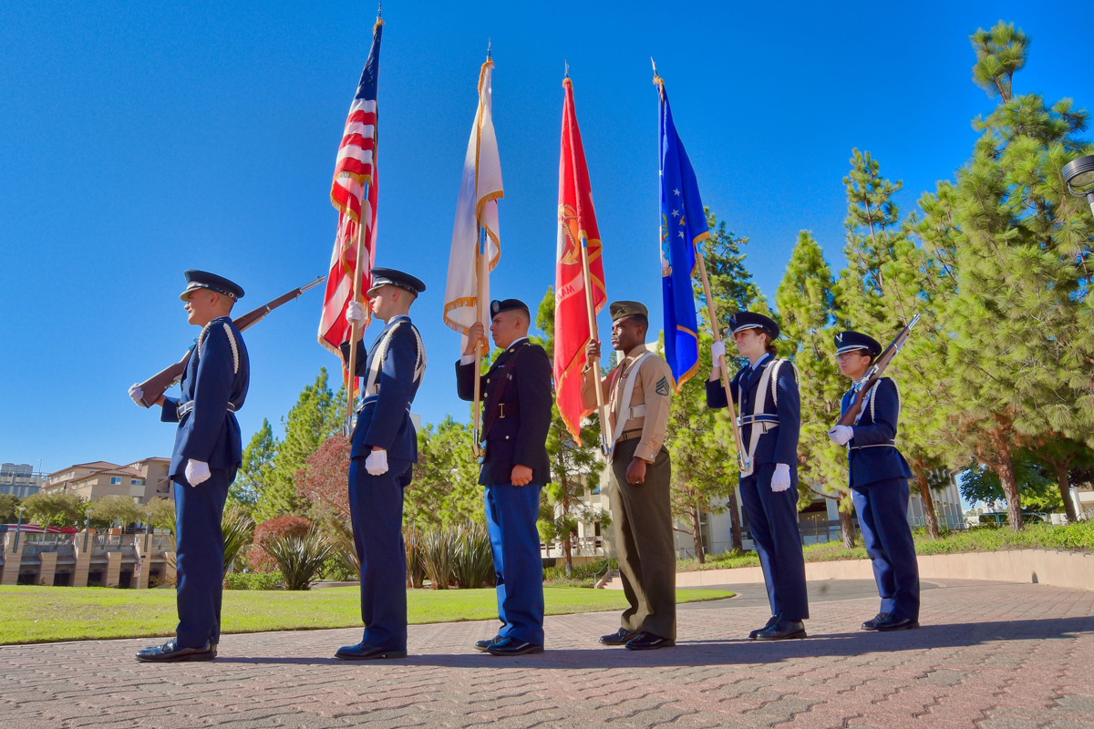 Members of the military stand at attention during an annual Wreath Laying Ceremony at the San Diego State War Memorial. Photo pr