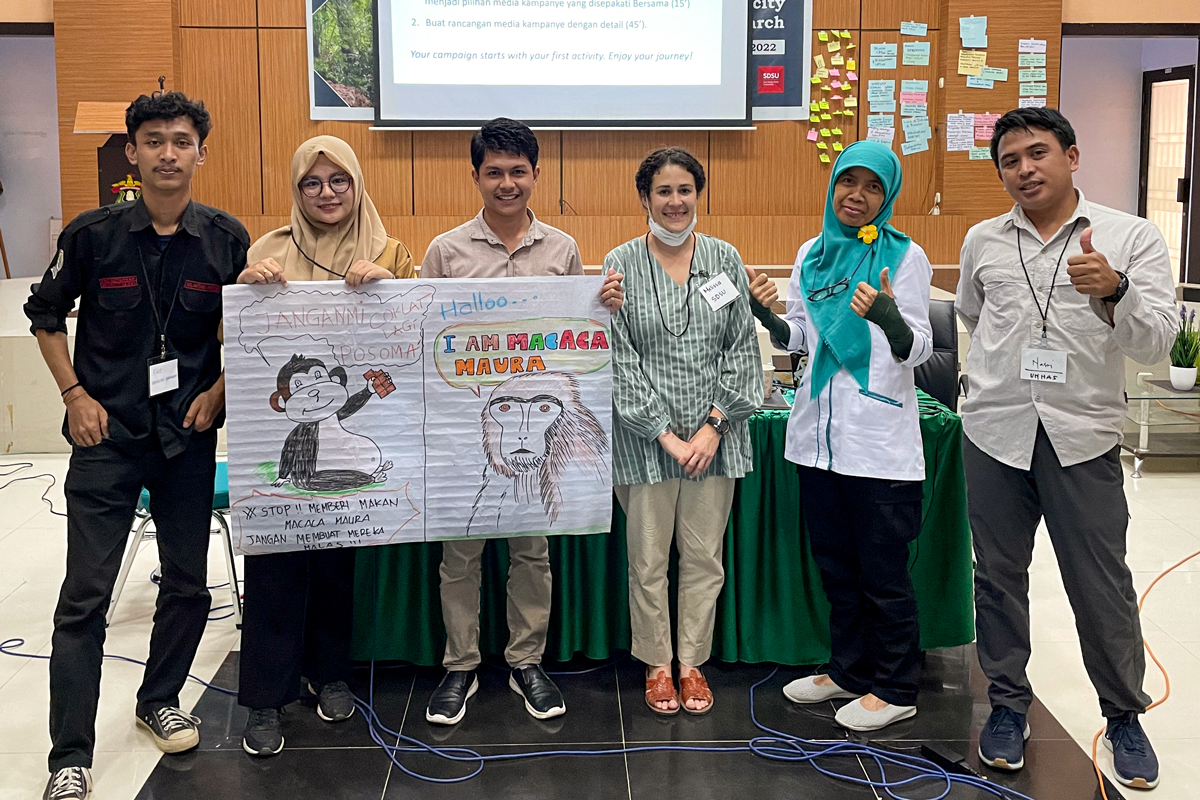 SDSU student and Indonesian students present concept for a children's book about a monkey.