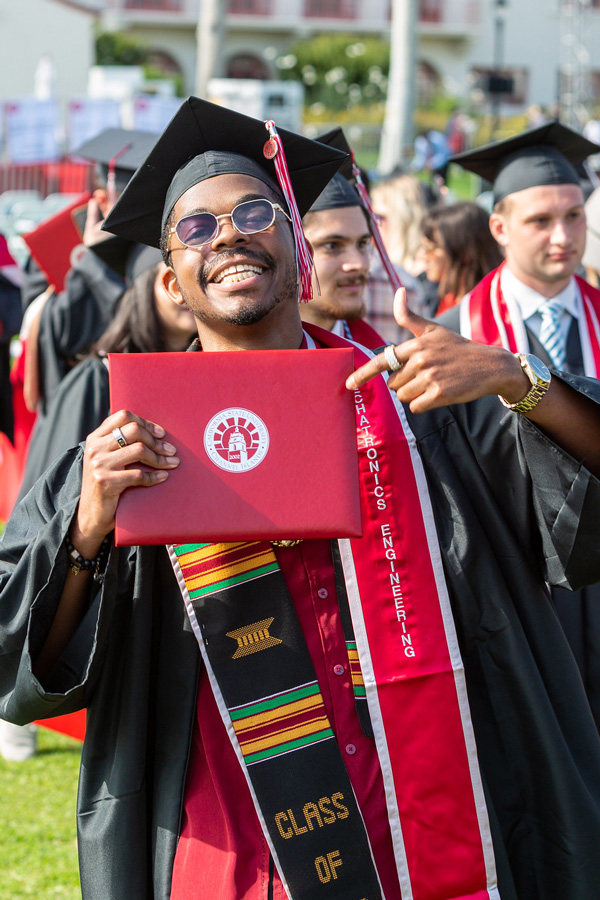 graduating student holding up diploma