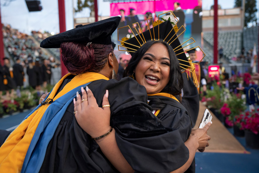 graduating student hugging professor