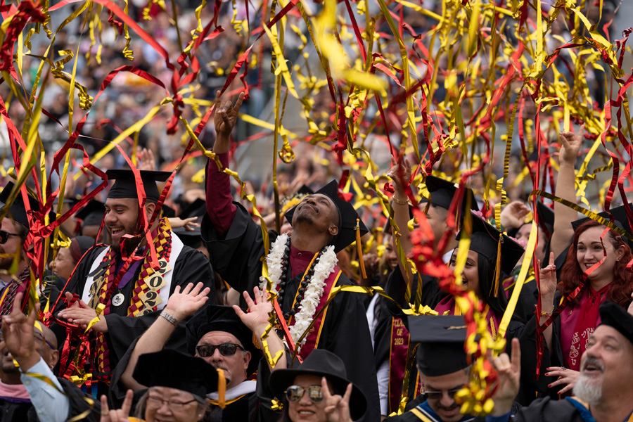 proud graduating student doing the dominguez hills toro sign in streamers