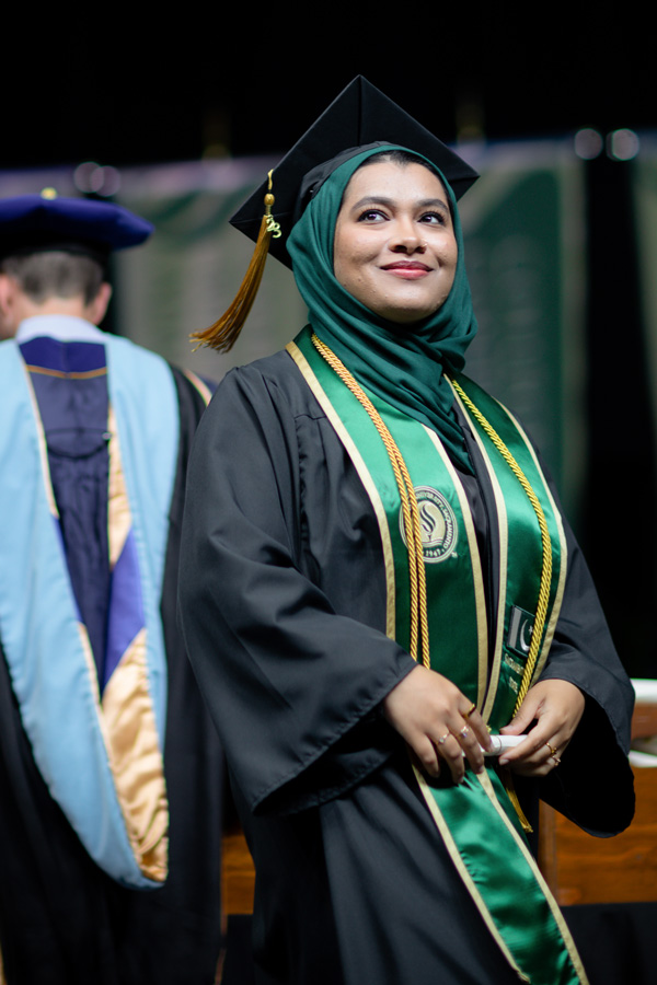 proud graduating student crossing the stage