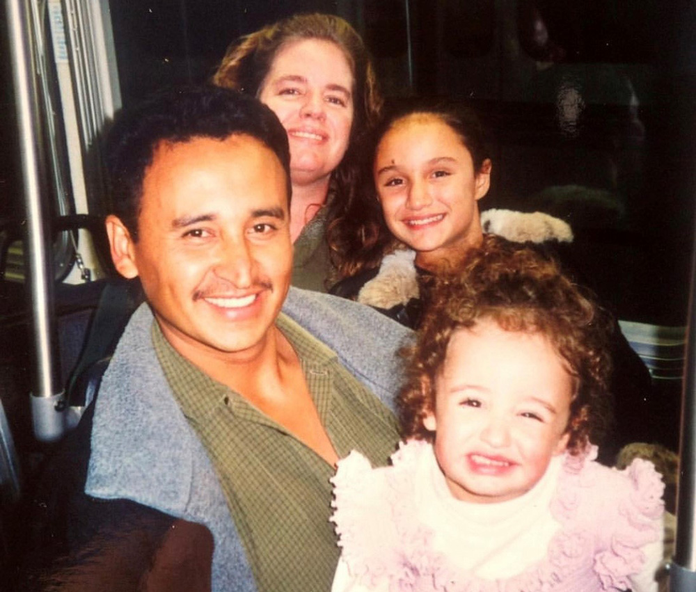 A younger Maria poses with her father, mother and sister.