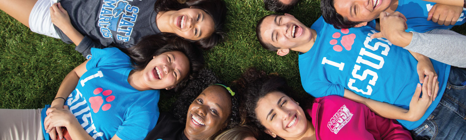 diverse students laying on grass