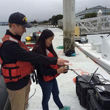 Interns Ben Potter (Cal Maritime) and Alice Dornblaser (Cal Poly SLO) pilot an ROV in Humboldt Bay, 2016