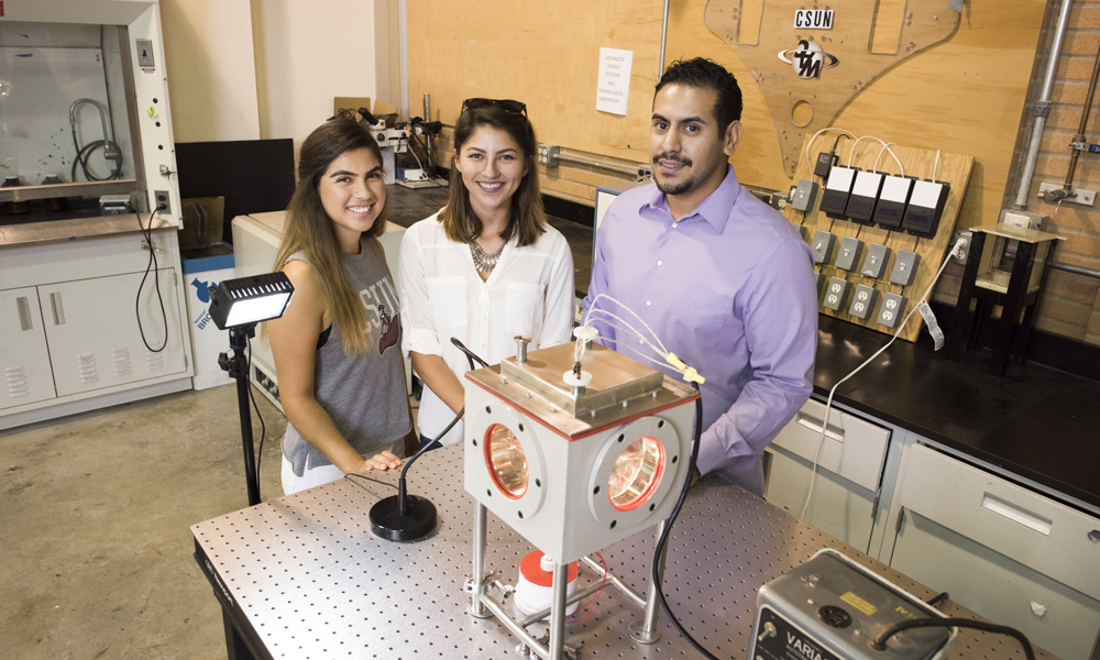 CSUN Students pose next to biomedical research tools