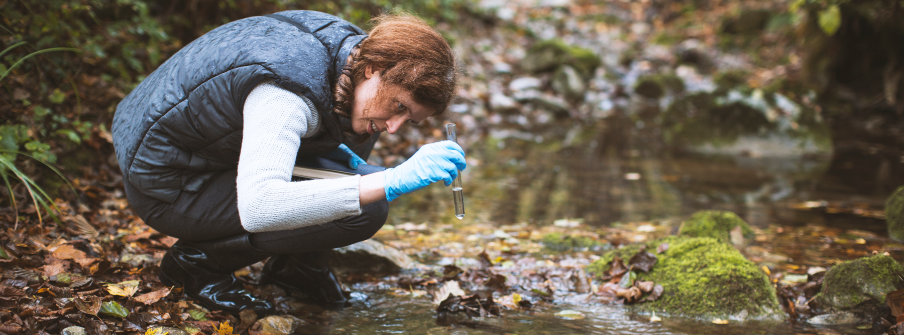 Student researcher examining water sample.