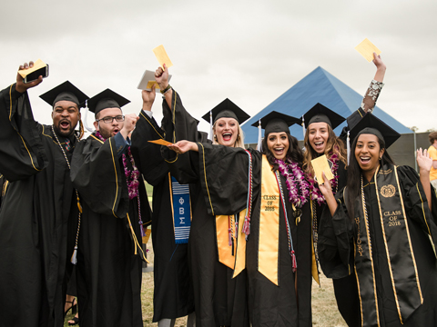 CSULB graduating students, posing in front of the Walter Pyramid 